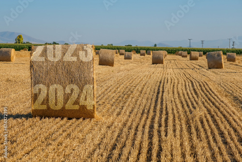 Happy New Year 2024 agricultural business concept. View of bales in the field. photo
