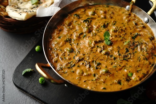 Homemade Methi Matar Malai -Indian vegetarian curry served with roti, selective focus photo