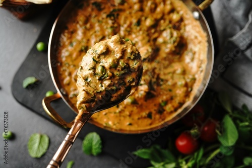 Homemade Methi Matar Malai -Indian vegetarian curry served with roti, selective focus photo