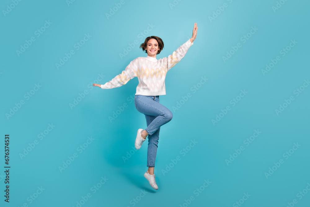 Full body photo of young woman bob brown hair jump air trampoline flying hands wings autumn clothes isolated on blue color background