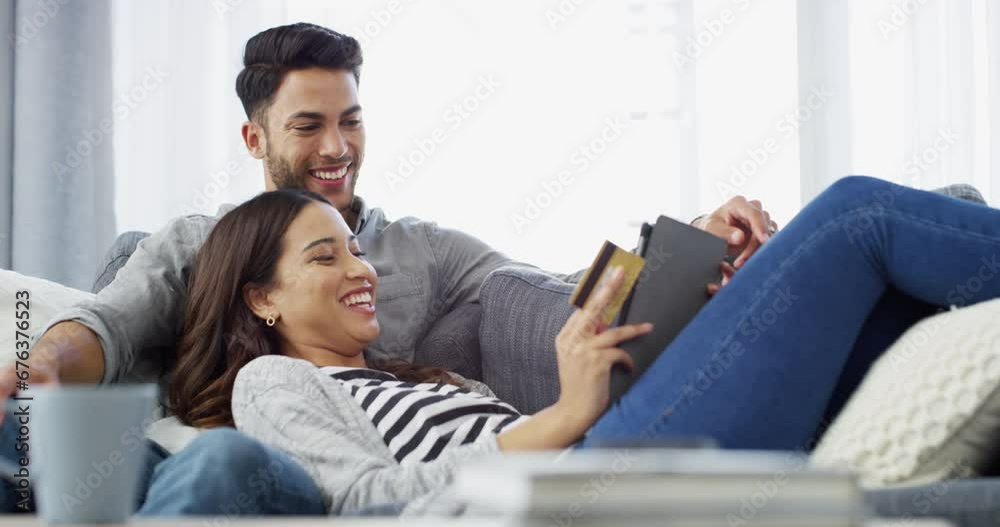 Couple, tablet and credit card for online payment with laughing, conversation and happiness with lying on sofa. Man, woman and retail shopping with technology, relaxing and happy on couch of lounge Couple, tablet and credit card for online payment with laughing, conversation and happiness with lying on sofa. Man, woman and retail shopping with technology, relaxing and happy on couch of lounge