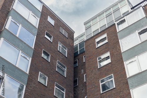 Looking up at two counsel estate buildings on overcast day