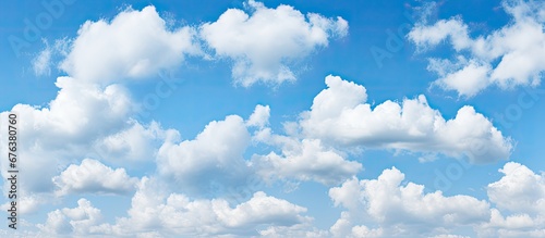 The blue sky and white fluffy clouds create a beautiful background pattern enhancing the beauty of the summer nature in spring with its light and space ultimately highlighting the vibrant c photo