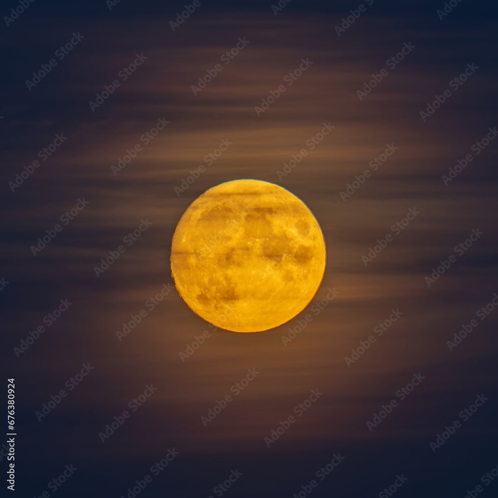 The big yellow moon shines in the sky