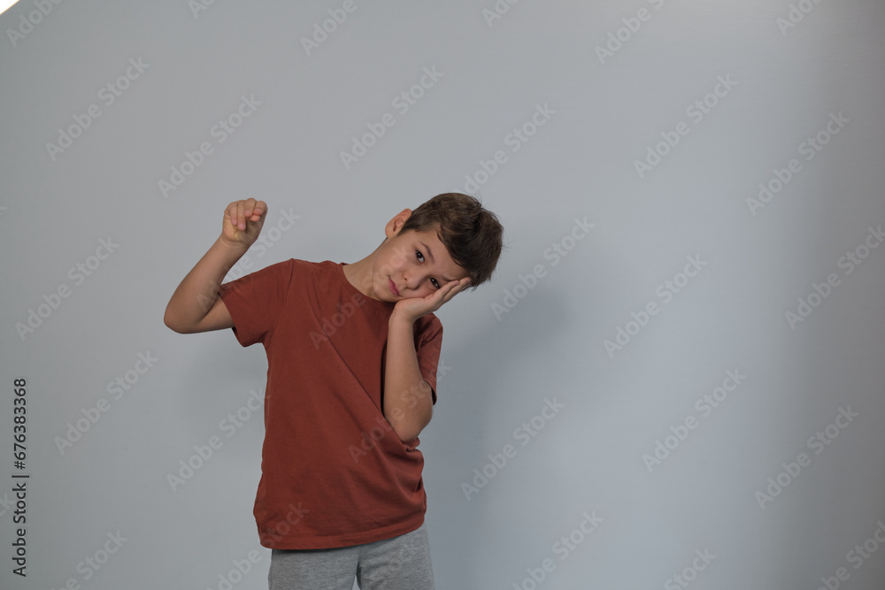 With his head propped on his hand, the boy's expression seems pensive. It subtly addresses the inner world of children amidst external chaos. With his head propped on his hand, the boy's expression seems pensive. It subtly addresses the inner world of children amidst external chaos.