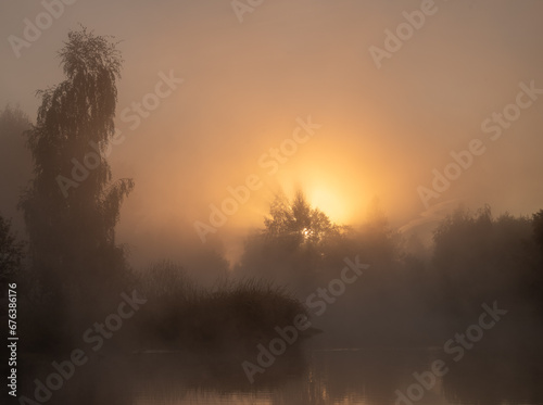 Dawn over a foggy river