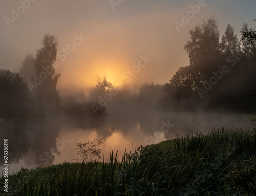 Dawn over a foggy river