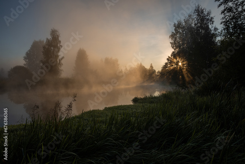 Dawn over a foggy river