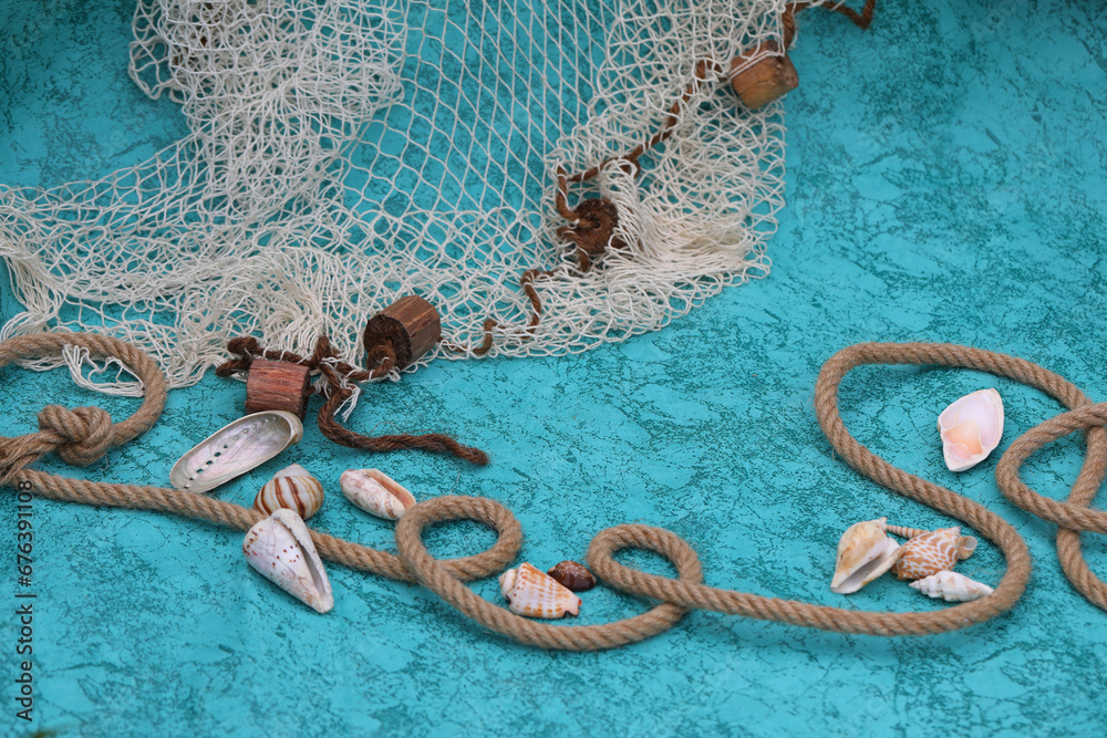 Deep blue background with shells, rope and fishnet Deep blue background with shells, rope and fishnet