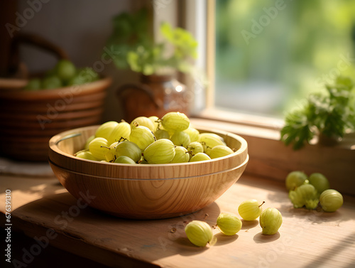 Fresh gooseberries in a wooden bowl on a kitchen table, blurred background 