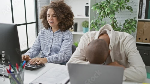 Tired man and woman, two hardworking workers, struggling with the grind of computer work in the office photo