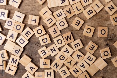 English alphabet. Wooden letters on a wooden background. A letter mess