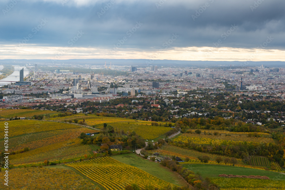 Naklejka premium Panoramic view from a vineyard hill over the Danube River in Vienna, Austria. Vienna, Austria, Europe, Donau Island, Danube River