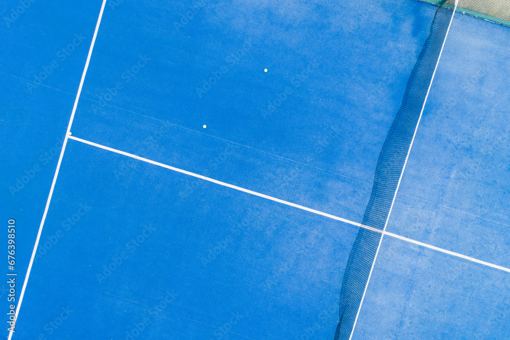 overhead aerial view with a drone of a blue paddle tennis court