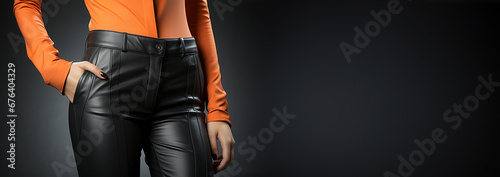 Woman with sexy legs wearing black leather pants and black high heels copy space. Fashion photo of a beautiful elegant young woman in a pretty suit, black leather pants, trousers, gray jacket, blazer,