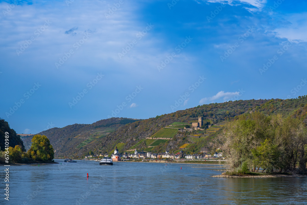 View over the Rhine on a sunny autumn day near Kaub/Germany with inland waterway vessels