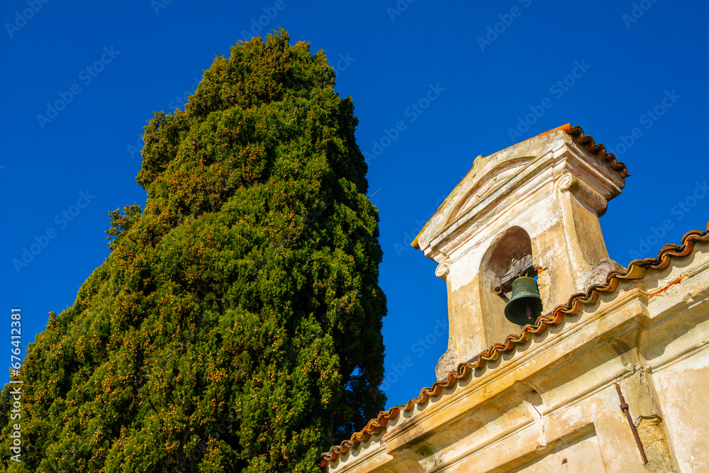 Church with Bell and a tree with Clear Blue Sky in Park San Michele in Castagnola in Lugano, Ticino in Switzerland.