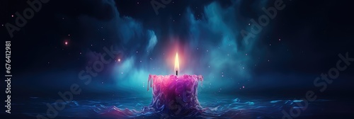 Purple candle burning on dark blue background with soft blurry lights and glittering . Esoteric spiritual practice, magical atmosphere. Advent candle with Season of Hope, All Souls Day