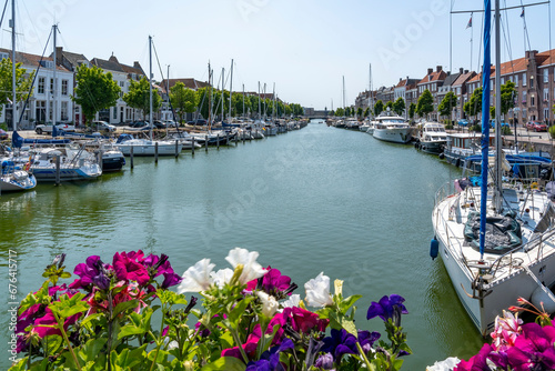 From the Spijkerbrug in Middelburg, decorated with petunias, you have a colorful view of the Binnenhaven with many recreational boats photo