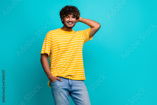Photo portrait of handsome young guy touch scratch back head dressed stylish striped yellow outfit isolated on cyan color background