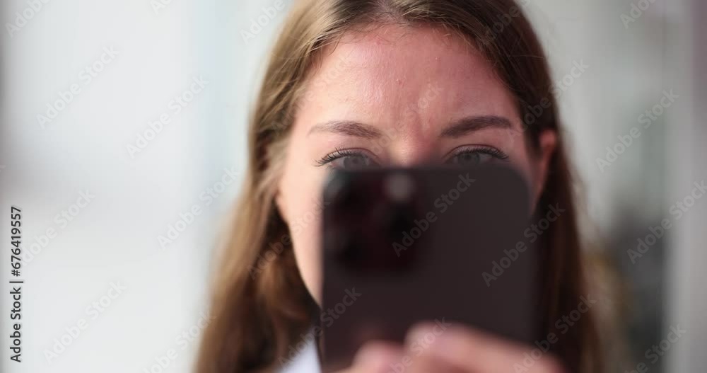 Beautiful woman thinks while looking at smartphone Beautiful woman thinks while looking at smartphone
