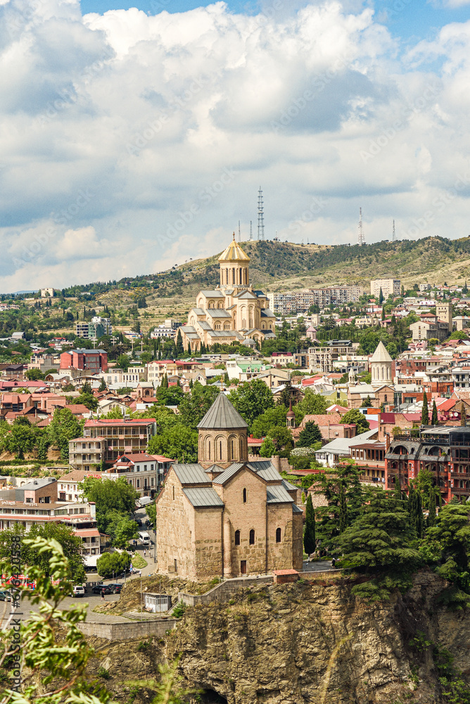 View of Holy Trinity Cathedral of Tbilisi and Metekhi, with parts of Tbilisi's Old Town seen on the horizon.