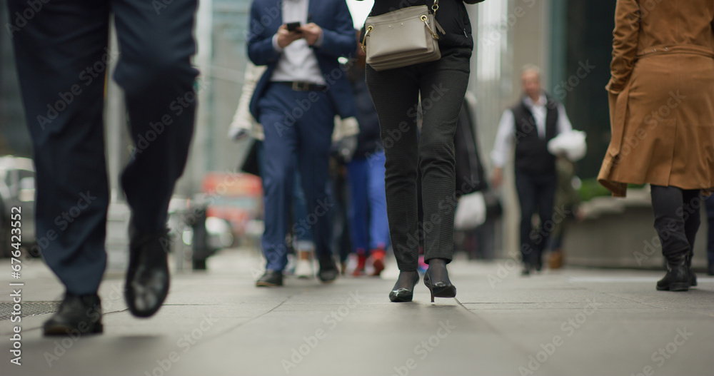 Crowd of people walking street low angle legs feet in city Crowd of people walking street low angle legs feet in city