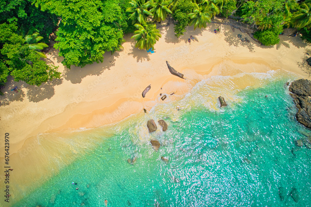 Bird eye drone photography of tourist in the beach, swimming and snorkelling, granite rocks, turquoise and transparent water, near the shore, sunset beach, Mahe, Seychelles  1