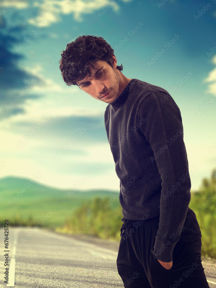 A man standing on the side of a road A man standing on the side of a road