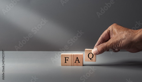 Принти на полотні hand posing FAQ, frequently asked questions, text FAQ, written on wooden cubes on  a grey blue background ,concept of customer service or assistance