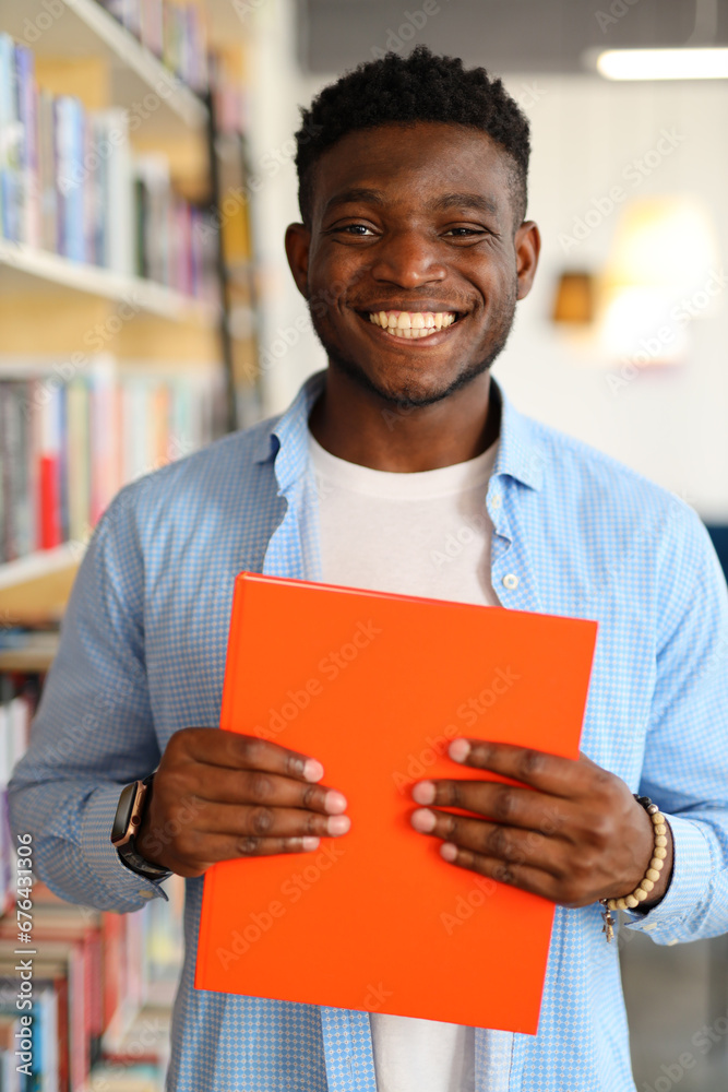 Happy African American student in a university library, studying with a smile amid books and knowledge. Happy African American student in a university library, studying with a smile amid books and knowledge.
