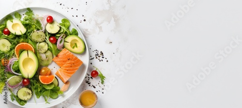 Fresh salmon fillets on plate with lemon and green lettuce leaves and spices, isolated on white background