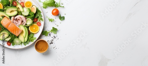 Fresh salmon fillets on  plate with lemon and green lettuce leaves and spices, isolated on white background