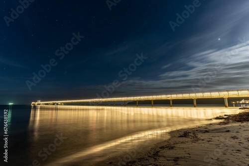 Long exposure shot of the pier in the seaside resort of Binz on the island of Rugen at night. photo
