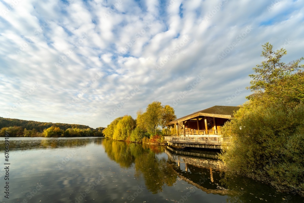 Fototapeta premium Scenic view of the Aileswasen lake surrounded by beautiful nature in autumn