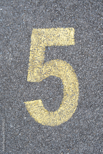 the number 5 five are drawn with color paint on asphalt. a children's playground designed a creative display of the alphabet educational element learning space.