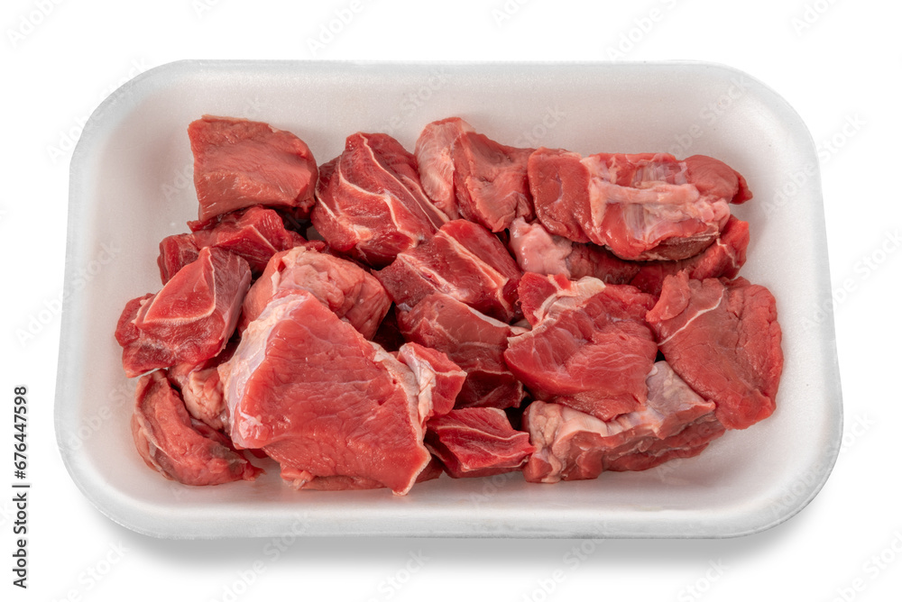 Raw diced red beef meat for Goulash or meat stew raw in food grade plastic tray. Isolated Raw diced red beef meat for Goulash or meat stew raw in food grade plastic tray. Isolated