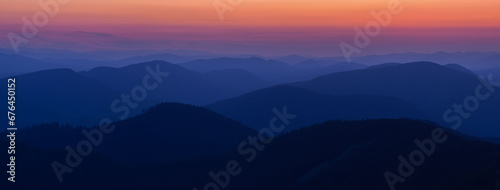 Panorama Silhouettes of Carpathian mountains in a natural blue-red gradient. Panorama of the Carpathian Mountains at dusk with silhouettes of ridges and peaks. Gorgany, Carpathians, Ukraine. photo