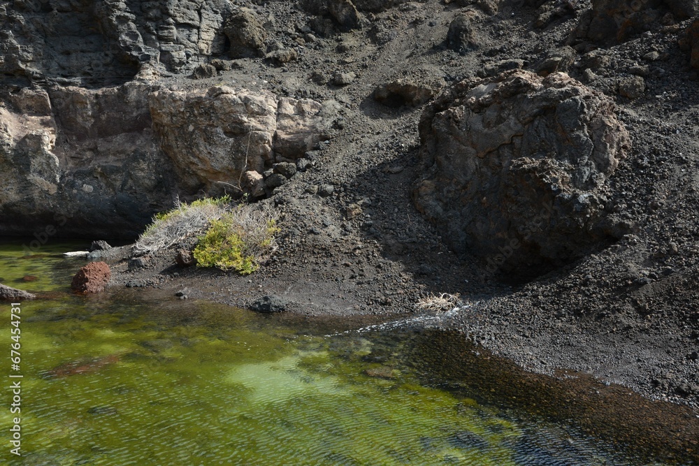 Coastal landscape with rocks and green water Coastal landscape with rocks and green water