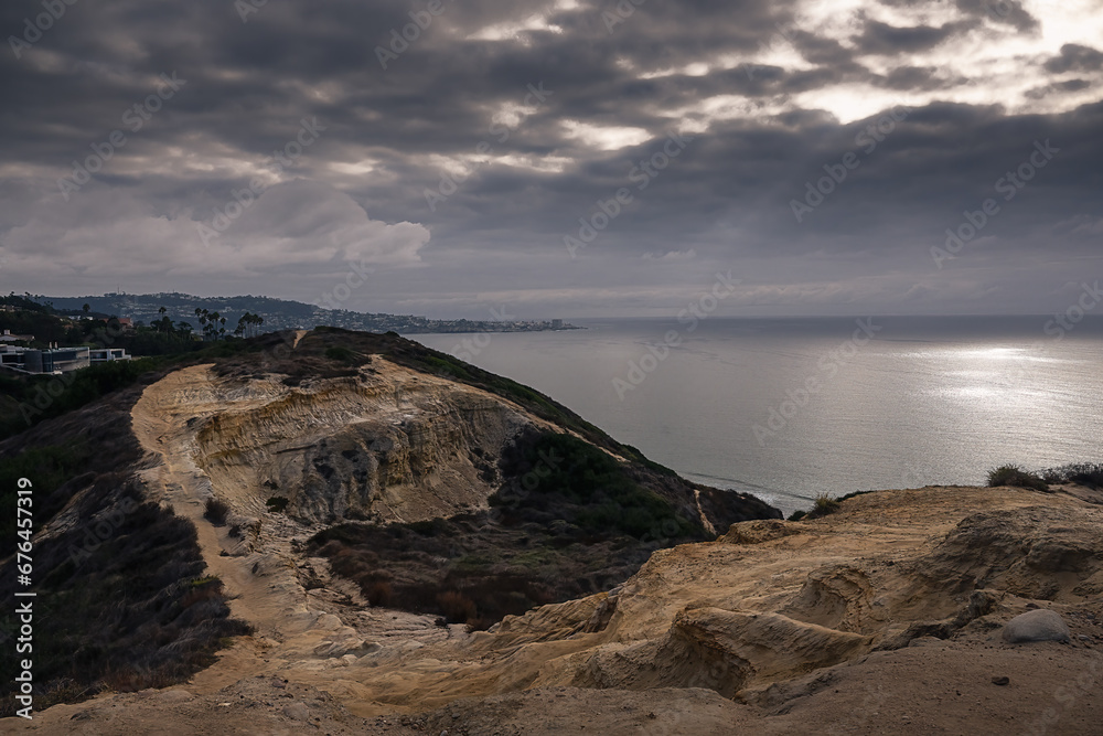 2023-10-25 HIKING RIDGE NEAR THE TORREY PINES GLIDER PORT WITH THE PACIFIC OCEAN WOTH A NICE REFLECTION AND LA JOLLA IN THE BACKGROUND AND A DARK CLOUDY SKY 2023-10-25 HIKING RIDGE NEAR THE TORREY PINES GLIDER PORT WITH THE PACIFIC OCEAN WOTH A NICE REFLECTION AND LA JOLLA IN THE BACKGROUND AND A DARK CLOUDY SKY