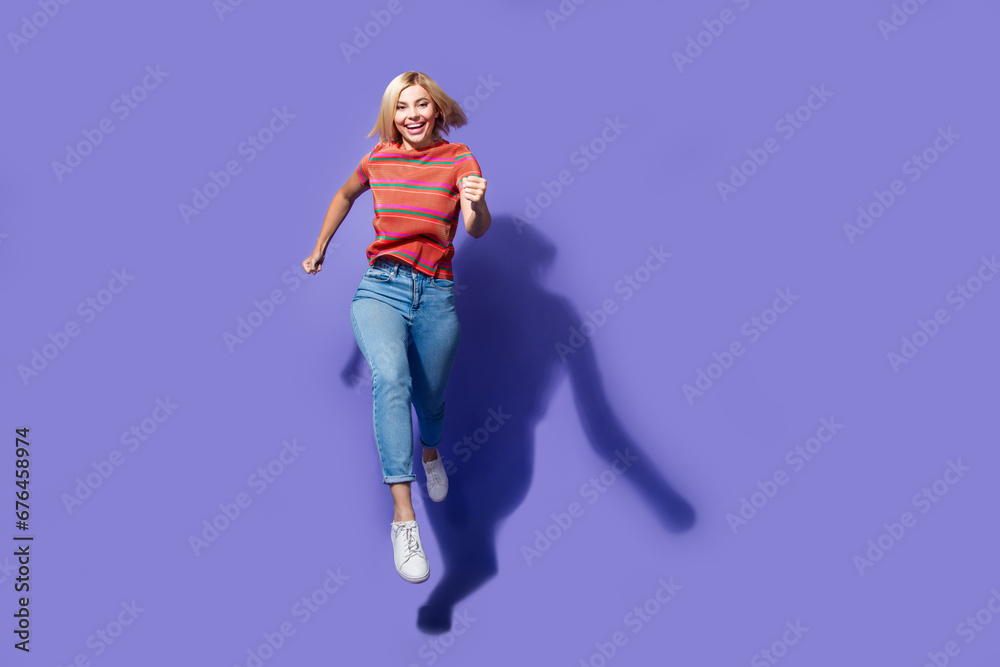 Full body size photo of running girl in air hurry to buy last piece in clothes store black friday isolated on violet color background Full body size photo of running girl in air hurry to buy last piece in clothes store black friday isolated on violet color background