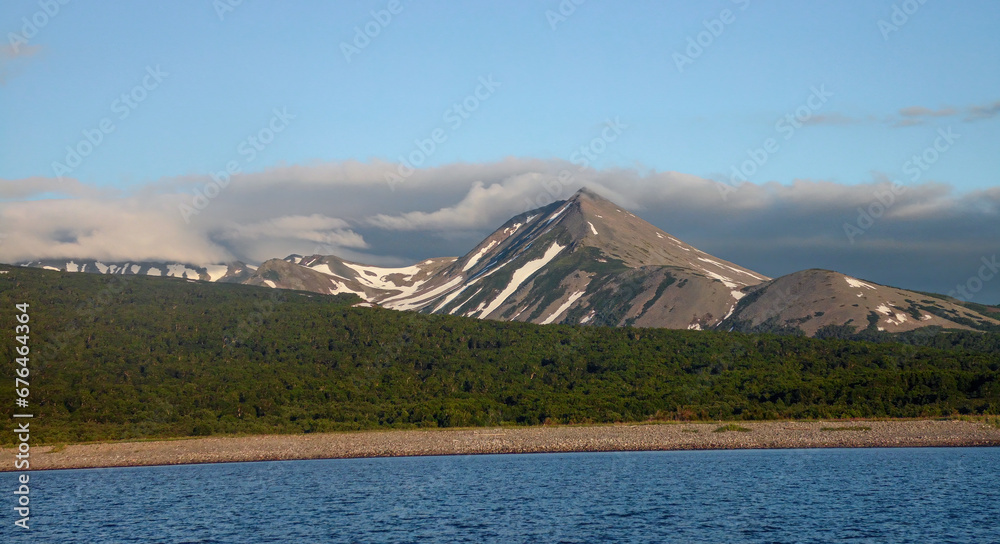 Fototapeta premium Peninsula Kamchatka Landscape. Small Snowy Mountains and Hills