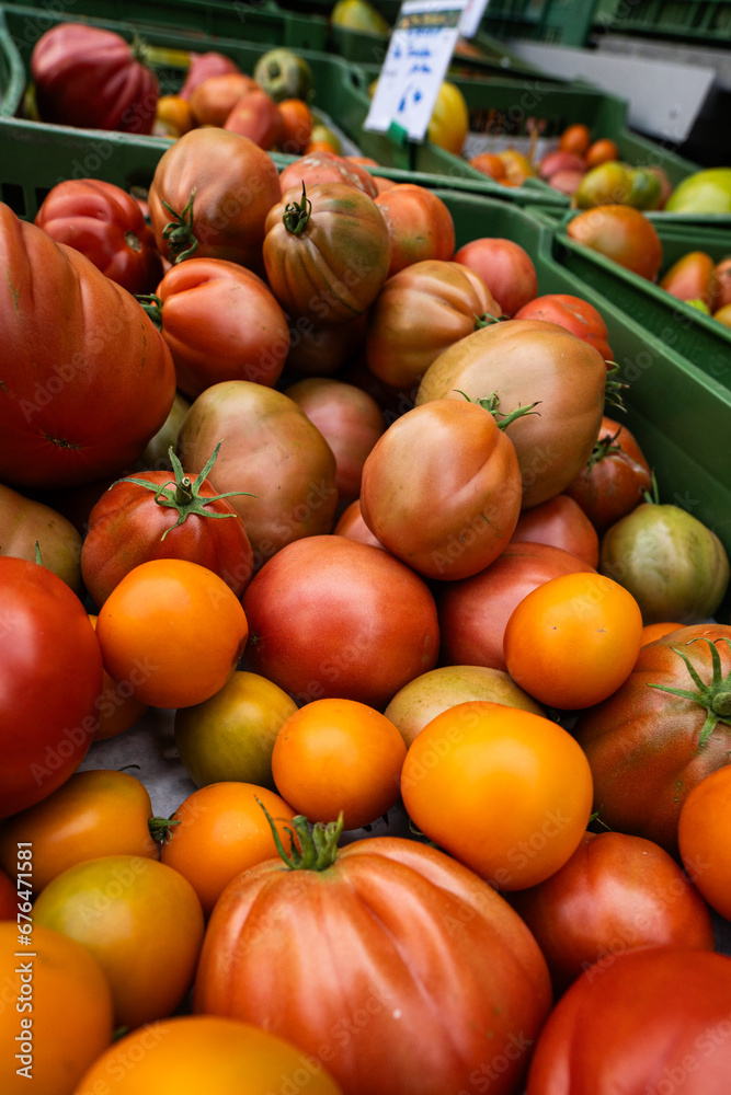 detail of ripe red tomatoes. Texture of many tomatoes in crates at the market