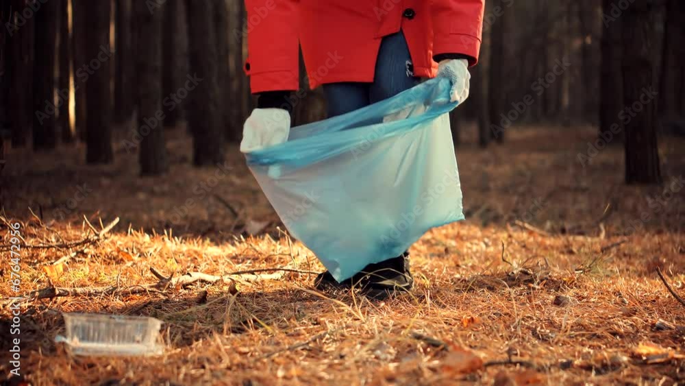Cleaner woman collecting trash in forest . Picking tidying trash recycling Cleaner woman collecting trash in forest . Picking tidying trash recycling