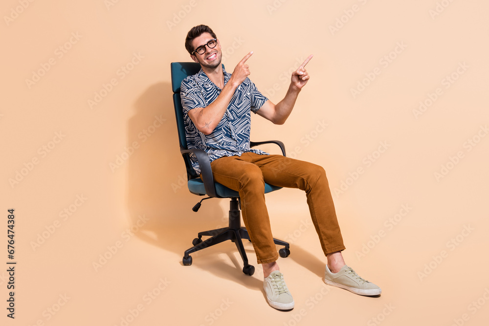 Full length photo of hr recruiter directing finger copy space introducing vacancy internship in company isolated on beige color background Full length photo of hr recruiter directing finger copy space introducing vacancy internship in company isolated on beige color background