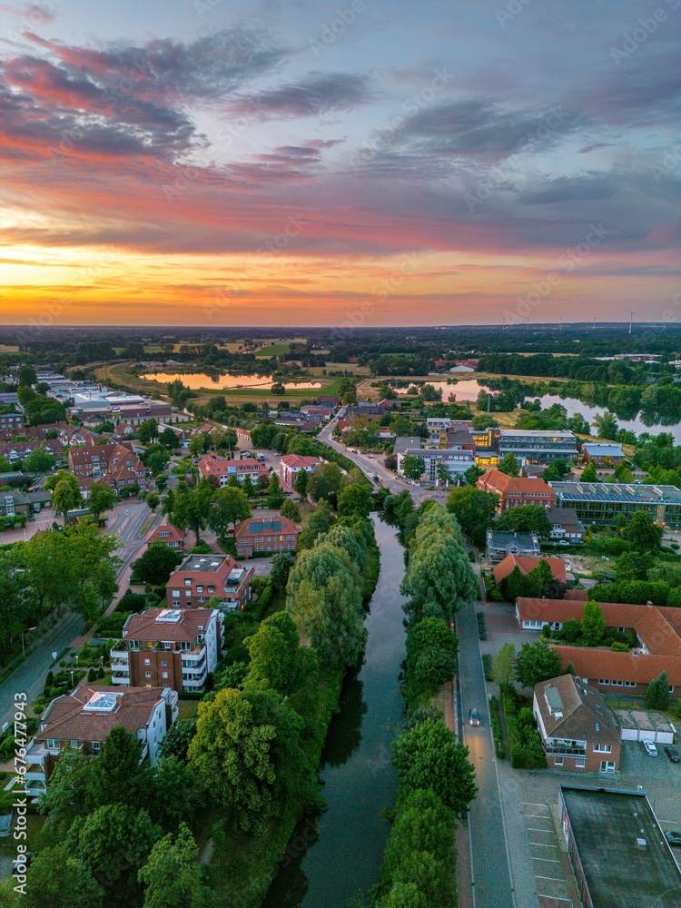 Vertical shot of the narrow river in Bramsche town in Germany at sunset