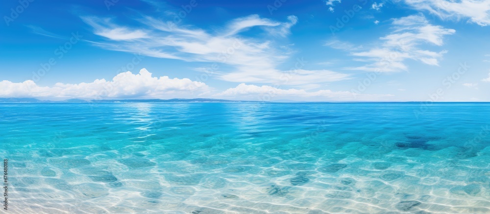 The blue ocean and beautiful coastline create a stunning landscape for travelers enjoying their summer holiday at the beach surrounded by the tranquility of nature and the wide open sky refl The blue ocean and beautiful coastline create a stunning landscape for travelers enjoying their summer holiday at the beach surrounded by the tranquility of nature and the wide open sky refl