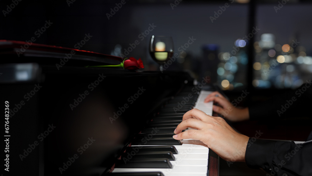 pianist hands playing piano music in dark night