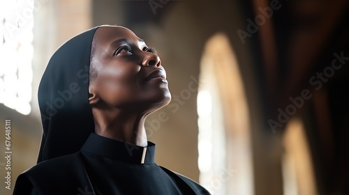 Middle aged African American nun praying