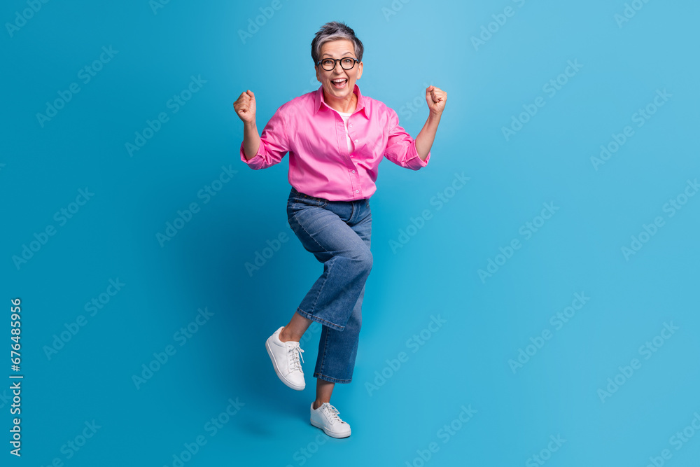 Full size photo of ecstatic overjoyed person wear stylish blouse in eyewear shout yeah win betting isolated on blue color background Full size photo of ecstatic overjoyed person wear stylish blouse in eyewear shout yeah win betting isolated on blue color background